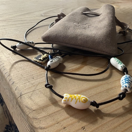 The Formentera Strand with painted ceramic fish beads on leather
