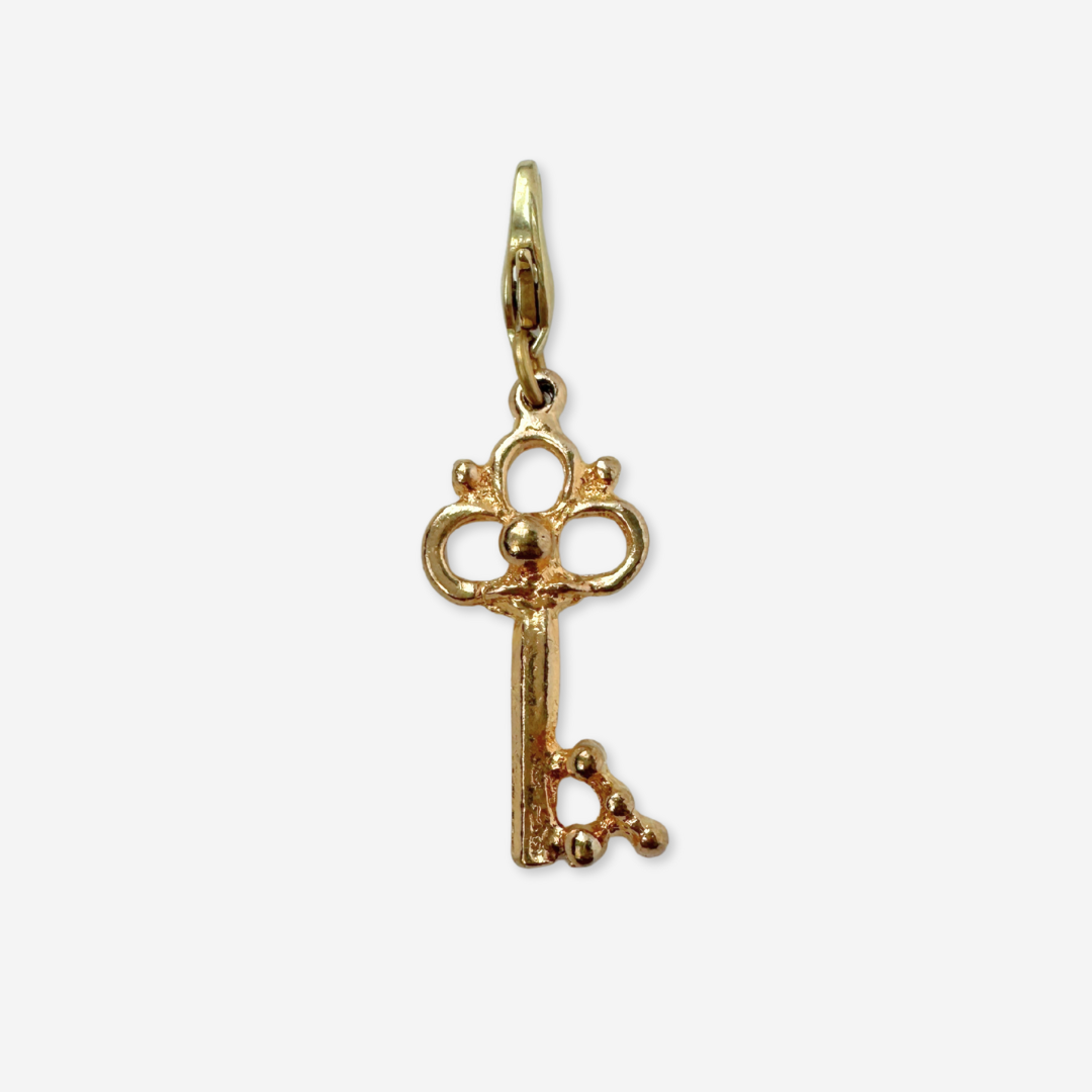 Small vintage gold tone skeleton key charm pendant